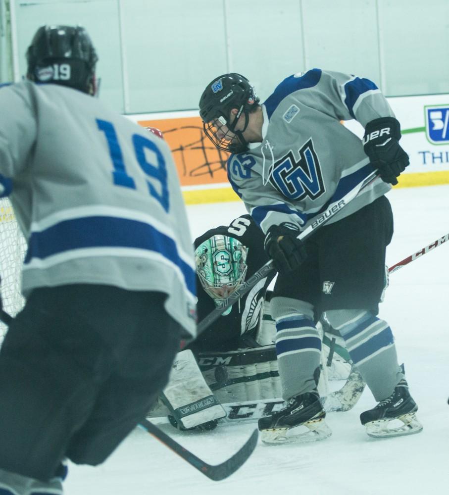 GVL / Kevin Sielaff - Mitch Lawton (25) tries a shot on net but the puck is handled by MSU's goaltender.  The Lakers’ D3 men’s hockey team blows out Michigan State at Eagle Ice Center in Grand Rapids on Friday, February 12, 2016.