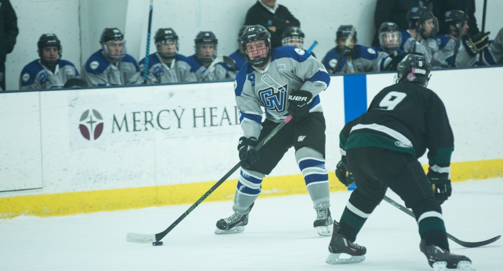 GVL / Kevin Sielaff - Zach Nash (13) looks to pass the puck. The Lakers’ D3 men’s hockey team blows out Michigan State at Eagle Ice Center in Grand Rapids on Friday, February 12, 2016.