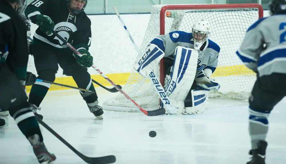 GVL / Kevin Sielaff - Goaltender Jack Lindsay (1) eyes a puck as it comes toward the net. The Lakers’ D3 men’s hockey team blows out Michigan State at Eagle Ice Center in Grand Rapids on Friday, February 12, 2016.