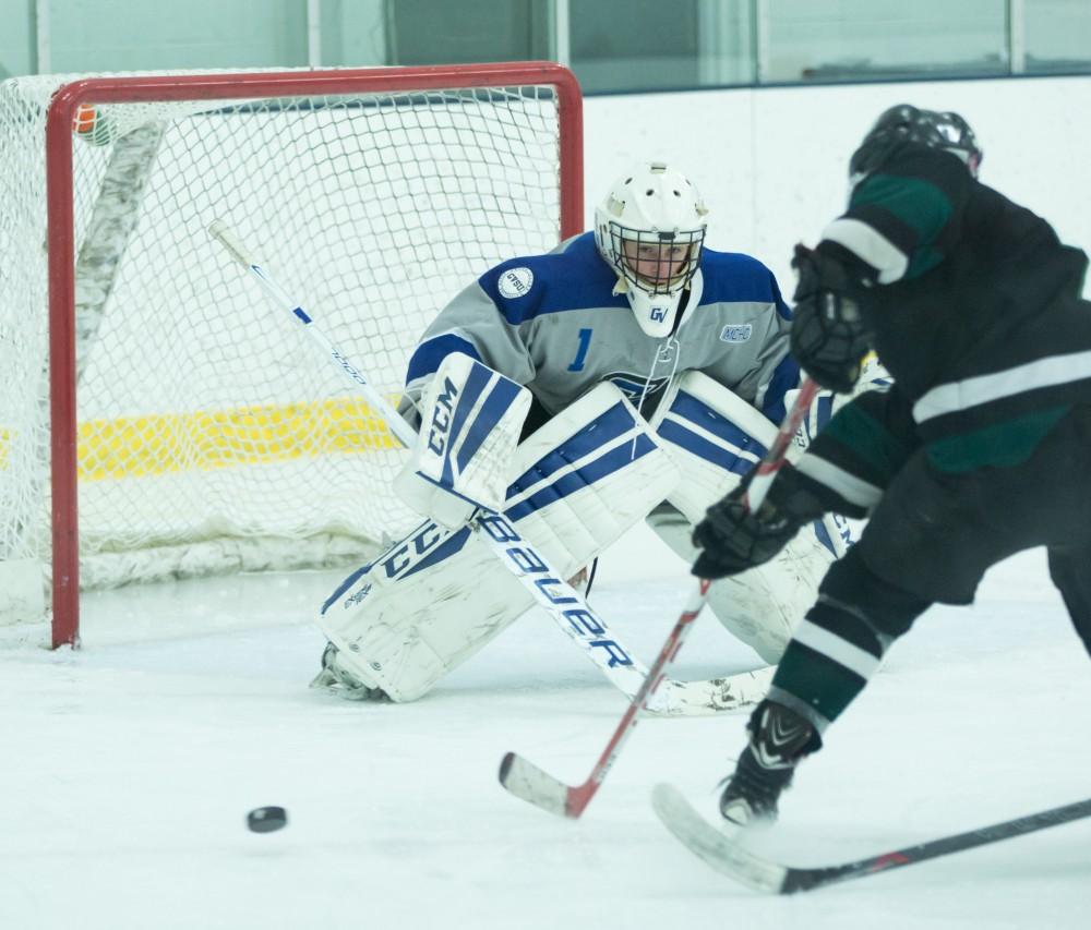 GVL / Kevin Sielaff - Goaltender Jack Lindsay (1) eyes the puck as it is poke checked off the stick of an MSU attacker. The Lakers’ D3 men’s hockey team blows out Michigan State at Eagle Ice Center in Grand Rapids on Friday, February 12, 2016.