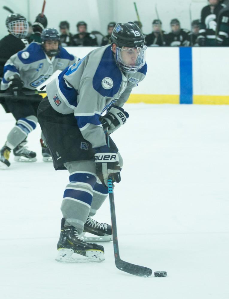 GVL / Kevin Sielaff - Blaine Marney (19) pushes the puck out in front of him and prepares to shoot.  The Lakers’ D3 men’s hockey team blows out Michigan State at Eagle Ice Center in Grand Rapids on Friday, February 12, 2016.