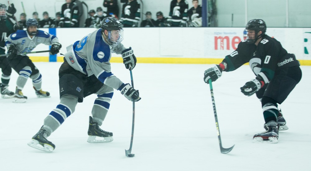 GVL / Kevin Sielaff - Blaine Marney (19) flexes his stick and shoots the puck on MSU's net.  The Lakers’ D3 men’s hockey team blows out Michigan State at Eagle Ice Center in Grand Rapids on Friday, February 12, 2016.