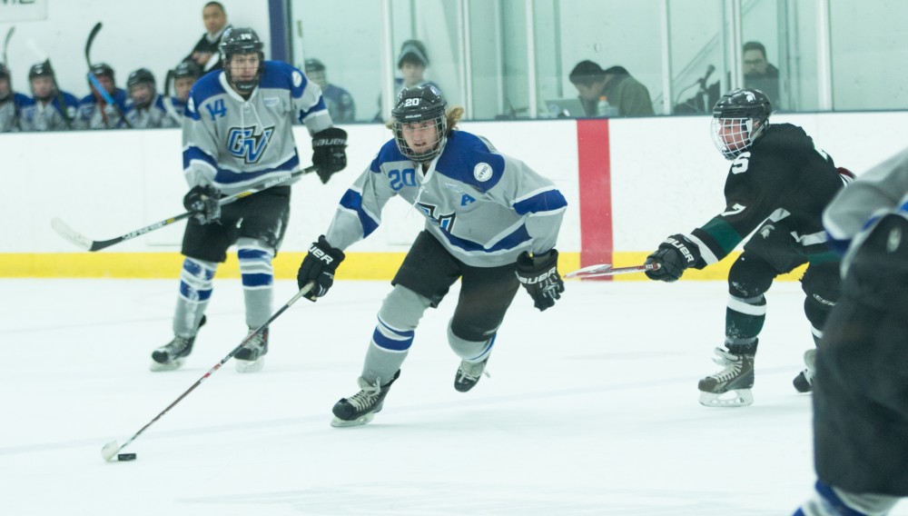 GVL / Kevin Sielaff - Nate Dykstra (20) skates the puck into MSU's zone. The Lakers’ D3 men’s hockey team blows out Michigan State at Eagle Ice Center in Grand Rapids on Friday, February 12, 2016.