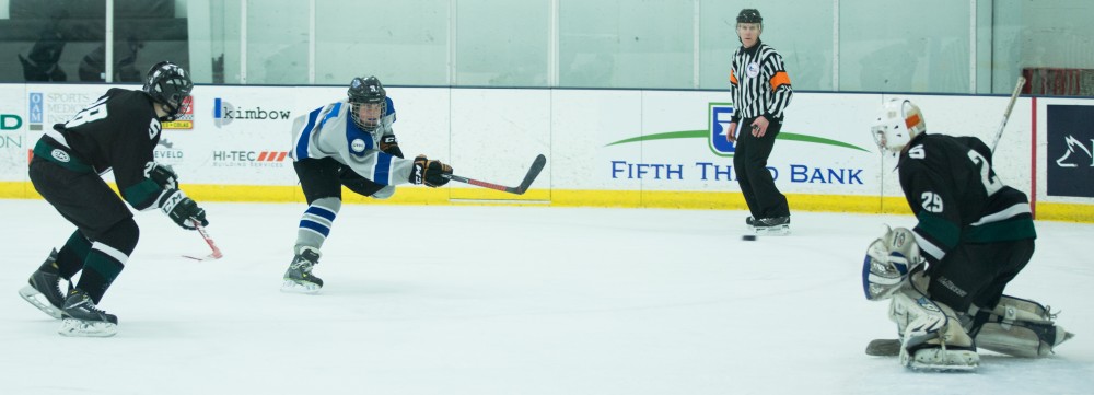 GVL / Kevin Sielaff - Danny Smith (3) tries a shot on net and scores.  The Lakers’ D3 men’s hockey team blows out Michigan State at Eagle Ice Center in Grand Rapids on Friday, February 12, 2016.