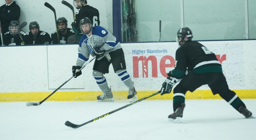 GVL / Kevin Sielaff - Eric White (18) looks to center the puck.  The Lakers’ D3 men’s hockey team blows out Michigan State at Eagle Ice Center in Grand Rapids on Friday, February 12, 2016.