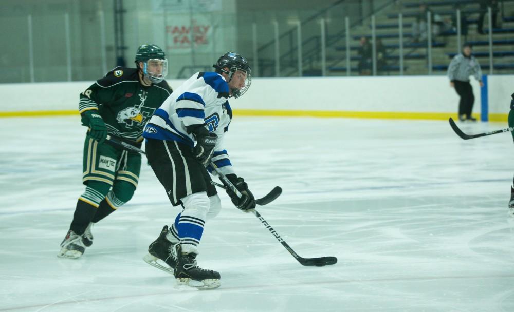 GVL / Kevin Sielaff - Troy Marrett (2) tries a shot on net.  The Lakers defeat the Eagles of Eatern Michigan University Friday, Feb. 5, 2016 at Georgetown Ice Center.