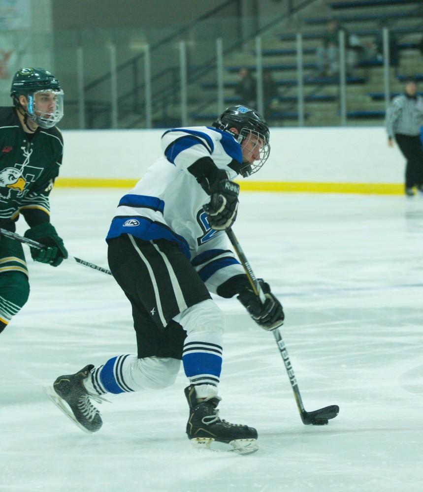 GVL / Kevin Sielaff - Troy Marrett (2) tries a shot on net in the first period.  The Lakers defeat the Eagles of Eatern Michigan University Friday, Feb. 5, 2016 at Georgetown Ice Center.