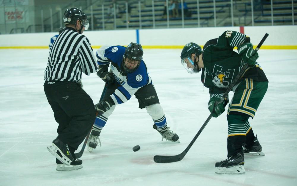 GVL / Kevin Sielaff - Alex Ostrowski (23) takes a face-off in Eastern's zone.  The Lakers defeat the Eagles of Eatern Michigan University Friday, Feb. 5, 2016 at Georgetown Ice Center.