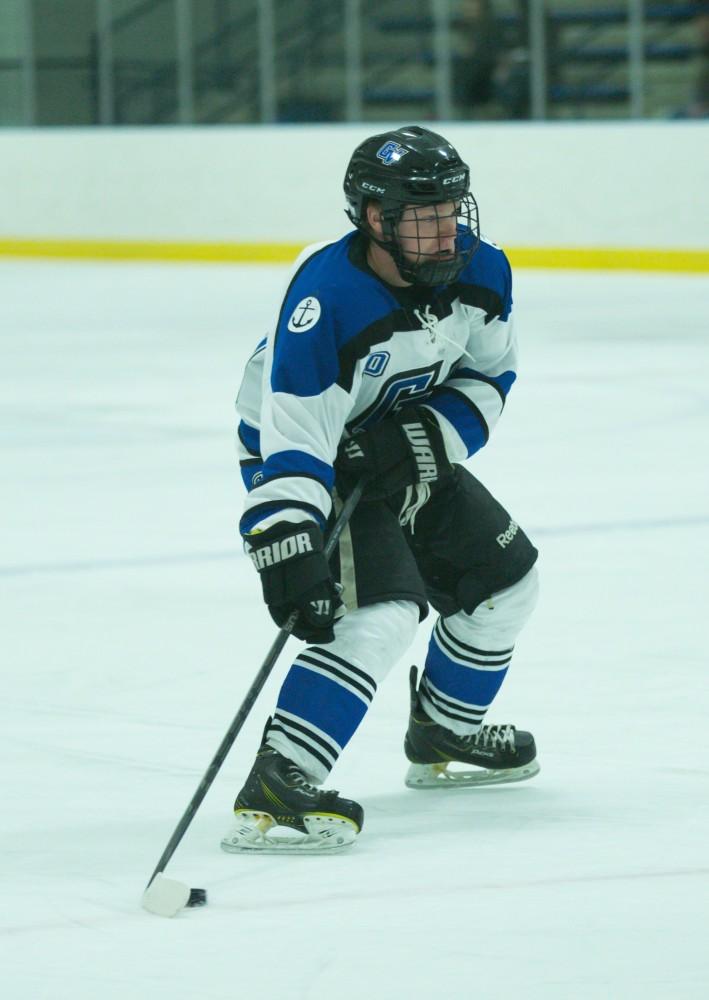 GVL / Kevin Sielaff - Mitch Claggett (10) dekes inside Eastern's zone and tries a shot on net.  The Lakers defeat the Eagles of Eatern Michigan University Friday, Feb. 5, 2016 at Georgetown Ice Center.