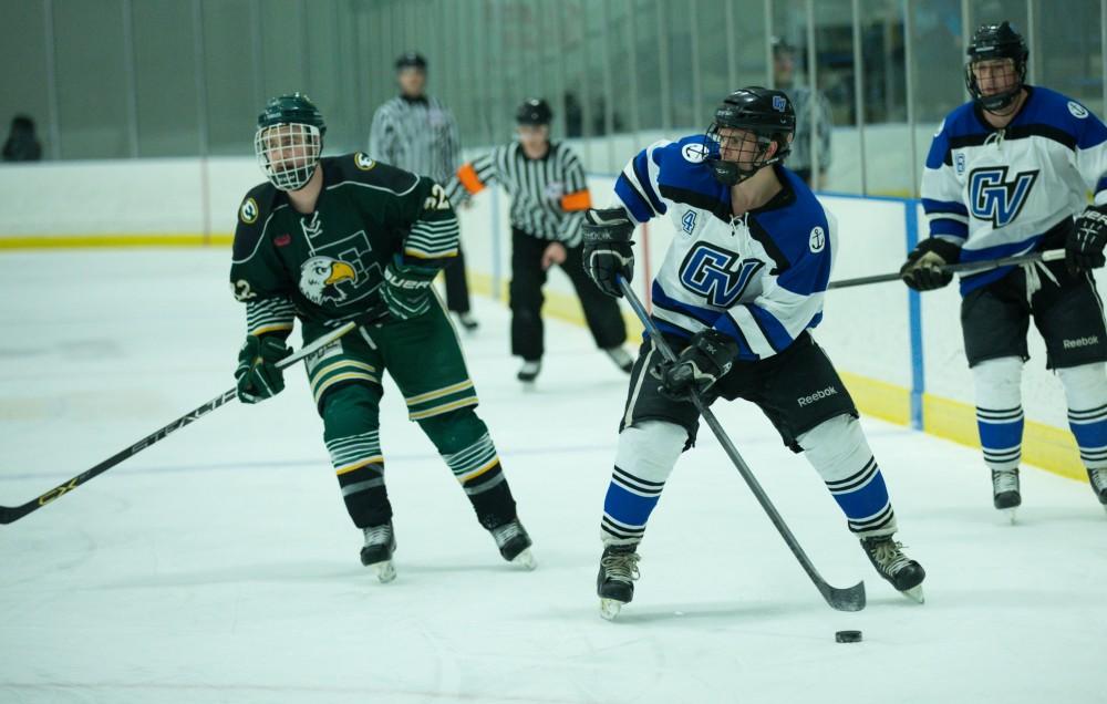 GVL / Kevin Sielaff - Tom Lusynski (4) looks to pass the puck.  The Lakers defeat the Eagles of Eatern Michigan University Friday, Feb. 5, 2016 at Georgetown Ice Center.