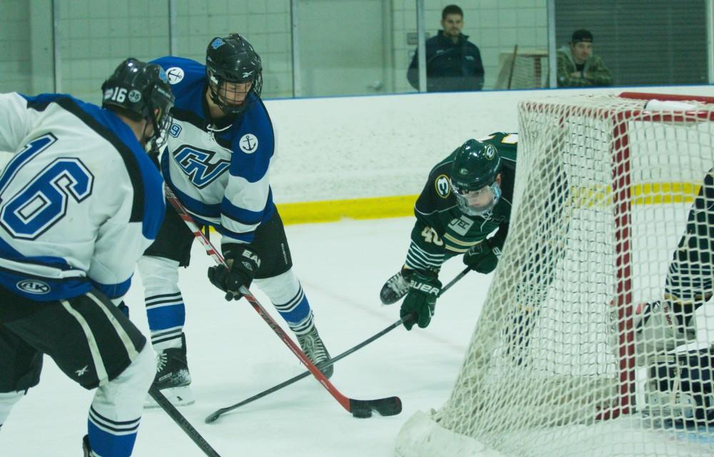 GVL / Kevin Sielaff - Collin Finkhouse (19) controls the puck behind Eastern's net.  The Lakers defeat the Eagles of Eatern Michigan University Friday, Feb. 5, 2016 at Georgetown Ice Center.