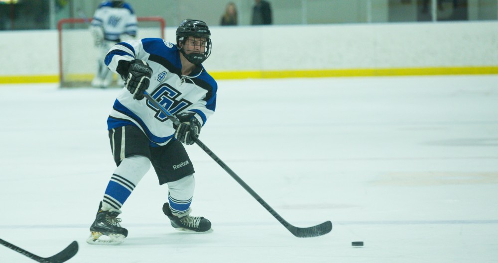 GVL / Kevin Sielaff - Tom Lusynski (4) fires off a pass to a teammate.  The Lakers defeat the Eagles of Eatern Michigan University Friday, Feb. 5, 2016 at Georgetown Ice Center.