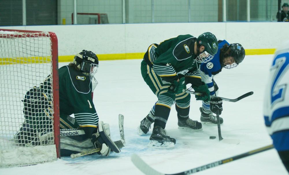 GVL / Kevin Sielaff - Corbin Rainey (27) fights to get a shot off in front of Eastern's net.  The Lakers defeat the Eagles of Eatern Michigan University Friday, Feb. 5, 2016 at Georgetown Ice Center.