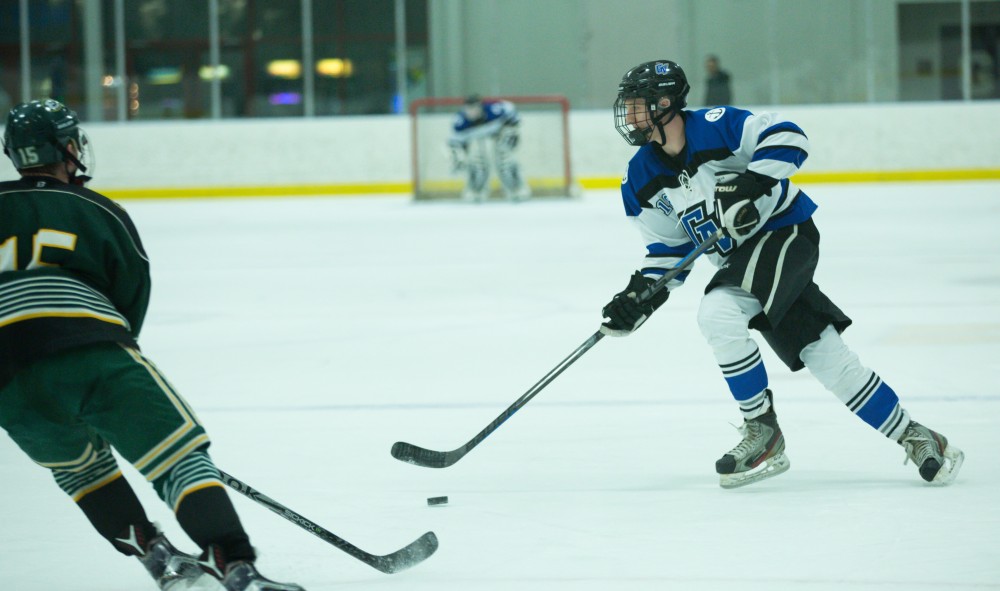 GVL / Kevin Sielaff - Vaughn Birchler (18) controls the puck in Eastern's zone.  The Lakers defeat the Eagles of Eatern Michigan University Friday, Feb. 5, 2016 at Georgetown Ice Center.