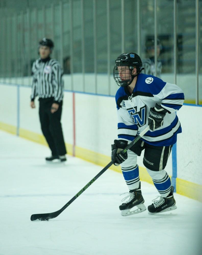 GVL / Kevin Sielaff - Reede Burnett (12) controls the puck in Eastern's zone.  The Lakers defeat the Eagles of Eatern Michigan University Friday, Feb. 5, 2016 at Georgetown Ice Center.