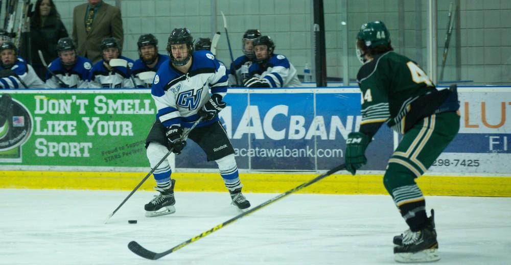 GVL / Kevin Sielaff - Corbin Rainey (27) controls the puck near the blue line in Eastern's zone.  The Lakers defeat the Eagles of Eatern Michigan University Friday, Feb. 5, 2016 at Georgetown Ice Center.