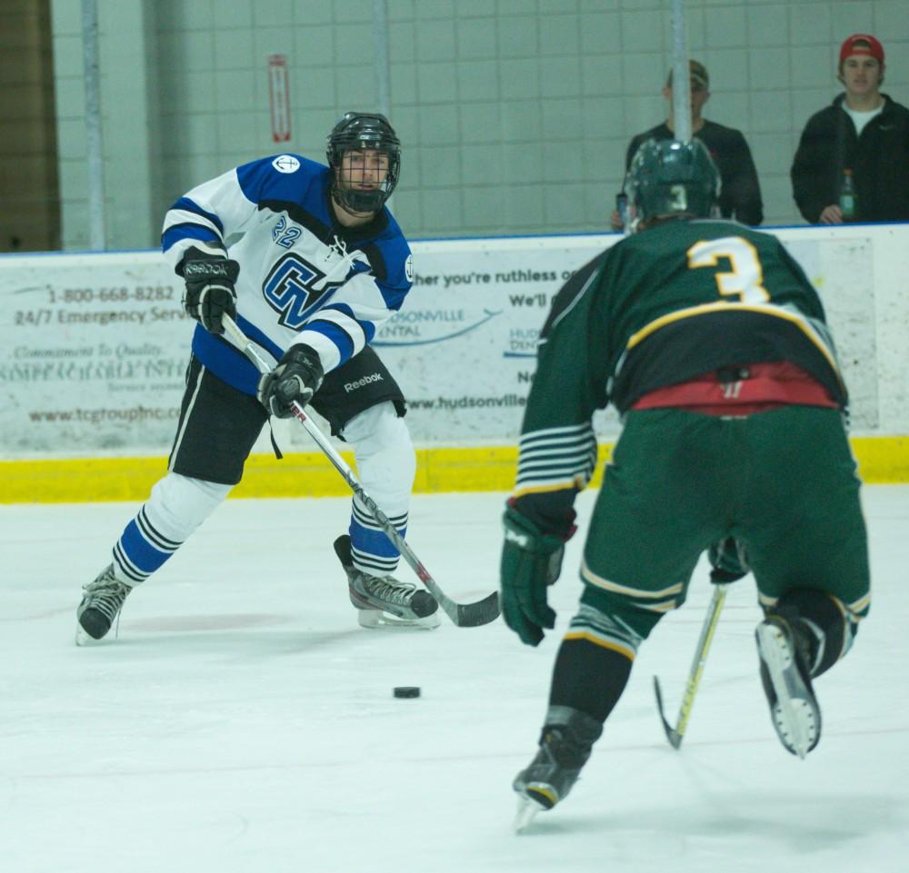 GVL / Kevin Sielaff - Zac Strain (22) crosses the puck.  The Lakers defeat the Eagles of Eatern Michigan University Friday, Feb. 5, 2016 at Georgetown Ice Center.