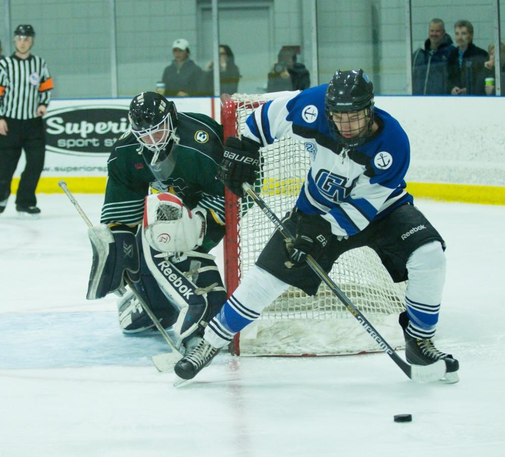 GVL / Kevin Sielaff - Nick Schultz (25) moves the puck at the side of Eastern's net.  The Lakers defeat the Eagles of Eatern Michigan University Friday, Feb. 5, 2016 at Georgetown Ice Center.