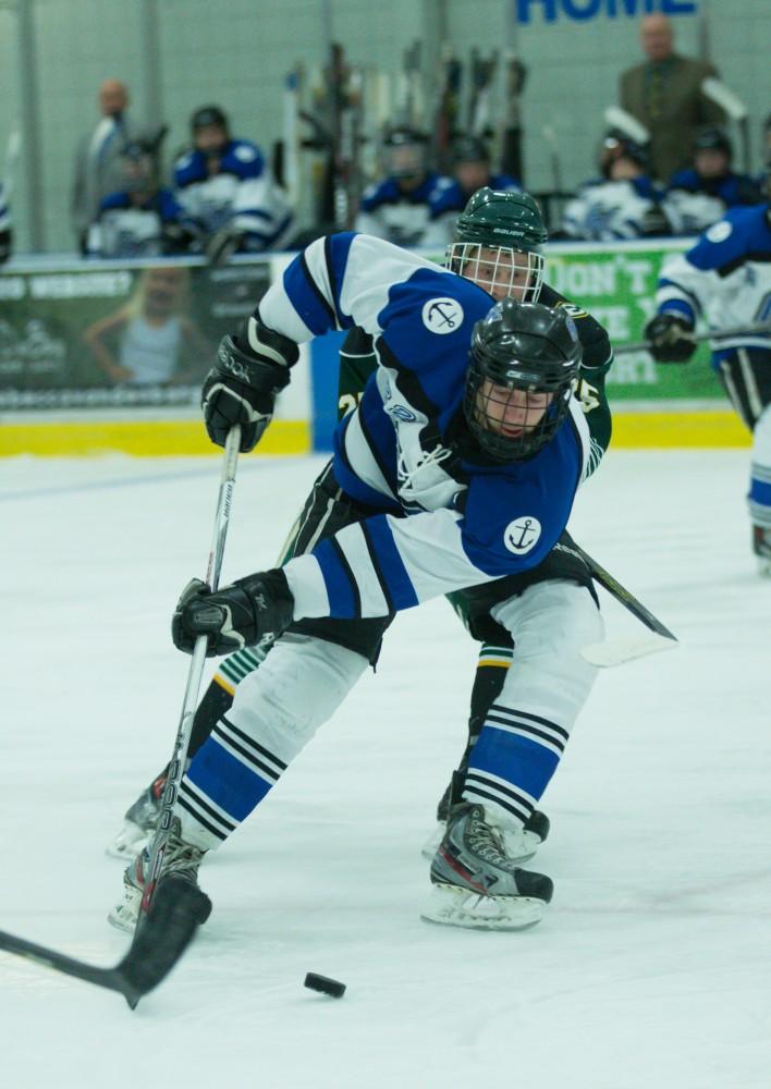 GVL / Kevin Sielaff - Zac Strain (22) fights his way into Eastern's zone.  The Lakers defeat the Eagles of Eatern Michigan University Friday, Feb. 5, 2016 at Georgetown Ice Center.