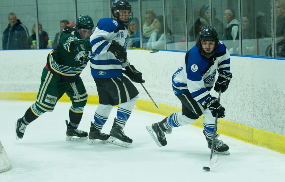 GVL / Kevin Sielaff - Corbin Rainey (27) regains posession of the puck behind Eastern's goal.  The Lakers defeat the Eagles of Eatern Michigan University Friday, Feb. 5, 2016 at Georgetown Ice Center.