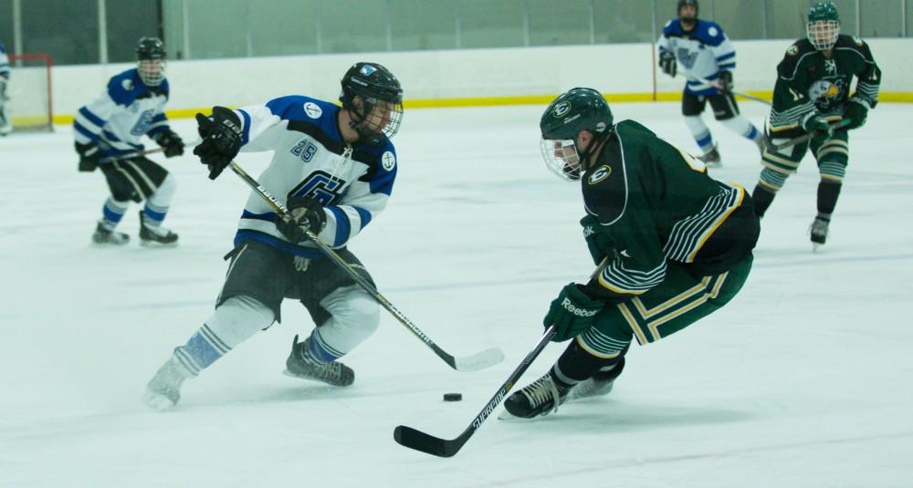 GVL / Kevin Sielaff - Nick Schultz (25) jukes around the Eastern defensive line.  The Lakers defeat the Eagles of Eatern Michigan University Friday, Feb. 5, 2016 at Georgetown Ice Center.