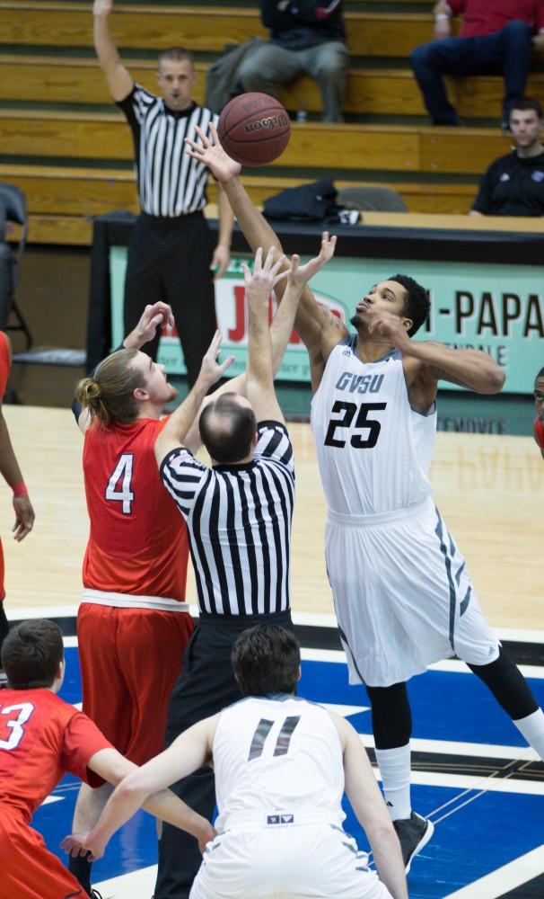 GVL / Kevin Sielaff - Chaz Rollins (25) takes the first jump ball of the game. The Lakers defeat the Cardinals of SVSU with a final score of 76-73 in Allendale.