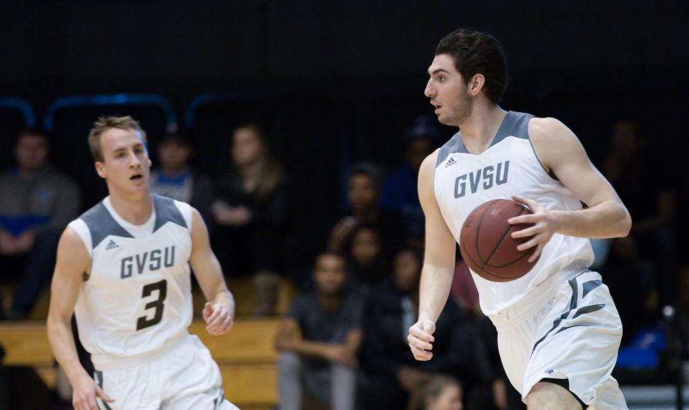 GVL / Kevin Sielaff - Zach West (11) dribbles the ball up the court. The Lakers defeat the Cardinals of SVSU with a final score of 76-73 in Allendale.