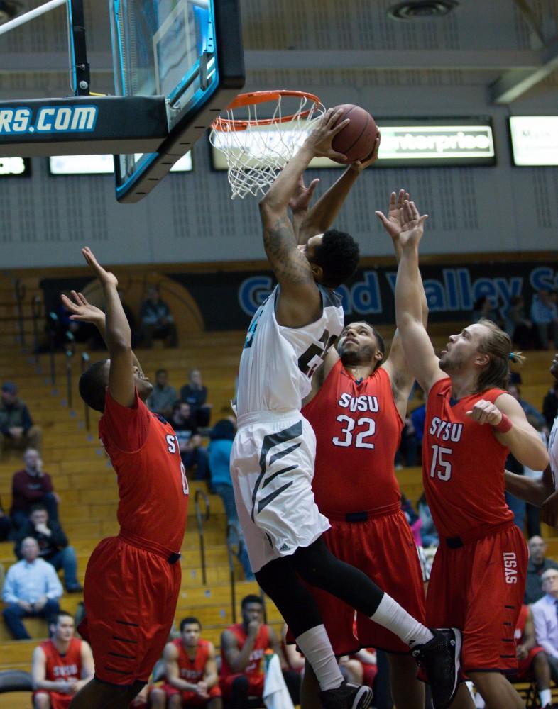 GVL / Kevin Sielaff - Chaz Rollins (25) pulls down an offensive board and takes the ball to the hoop. The Lakers defeat the Cardinals of SVSU with a final score of 76-73 in Allendale.