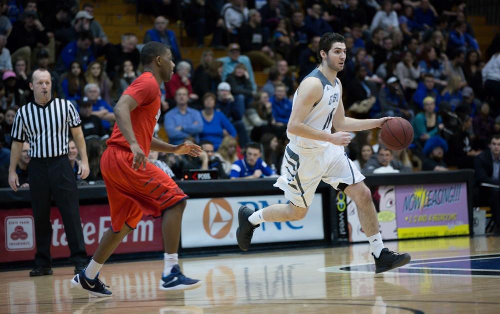 GVL / Kevin Sielaff - Zach West (11) dribbles the ball and looks for a pass. The Lakers defeat the Cardinals of SVSU with a final score of 76-73 in Allendale.