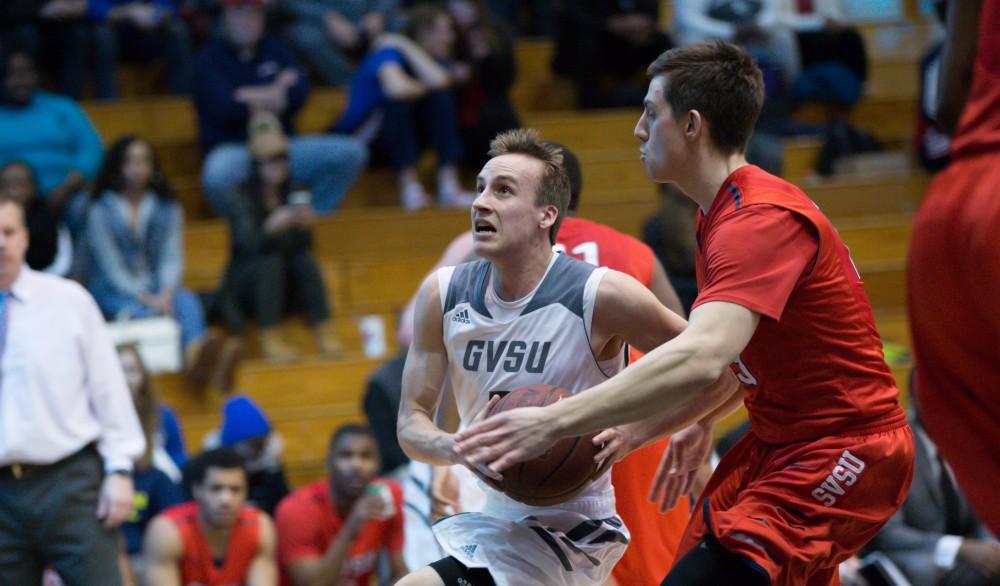 GVL / Kevin Sielaff - Darren Kapustka (3) goes in for a layup attempt. The Lakers defeat the Cardinals of SVSU with a final score of 76-73 in Allendale.