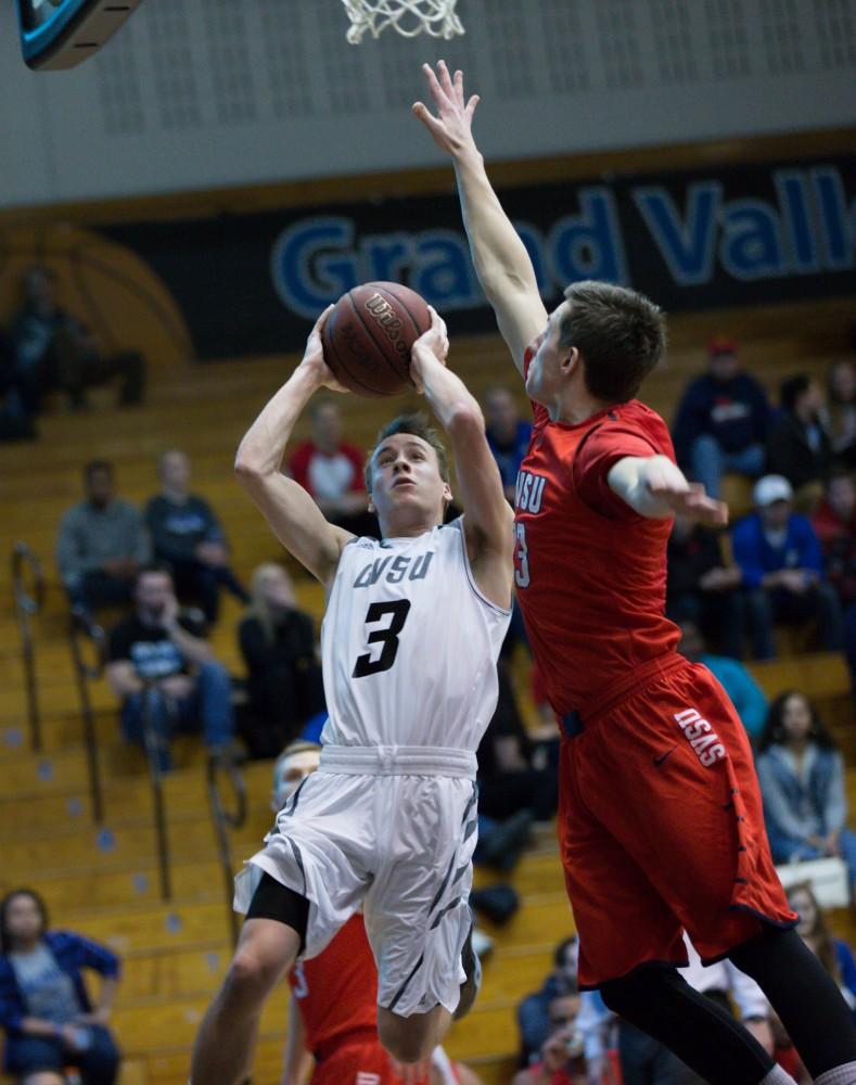 GVL / Kevin Sielaff - Darren Kapustka (3) tries a shot range shot. The Lakers defeat the Cardinals of SVSU with a final score of 76-73 in Allendale.