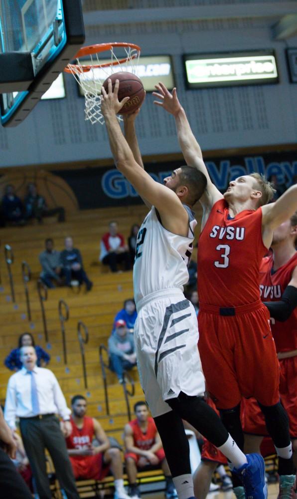 GVL / Kevin Sielaff - Ricardo Carbajal (32) drives hard to the hoop. The Lakers defeat the Cardinals of SVSU with a final score of 76-73 in Allendale.