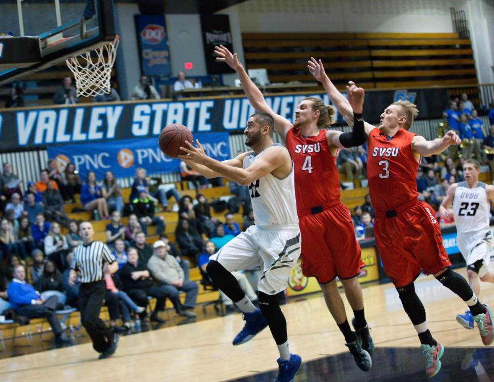 GVL / Kevin Sielaff - Ricardo Carbajal (32) goes in for the layup and is contested by the SVSU defense. The Lakers defeat the Cardinals of SVSU with a final score of 76-73 in Allendale.