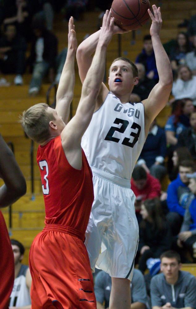 GVL / Kevin Sielaff - Luke Ryskamp (23) tries a long two point shot. The Lakers defeat the Cardinals of SVSU with a final score of 76-73 in Allendale.