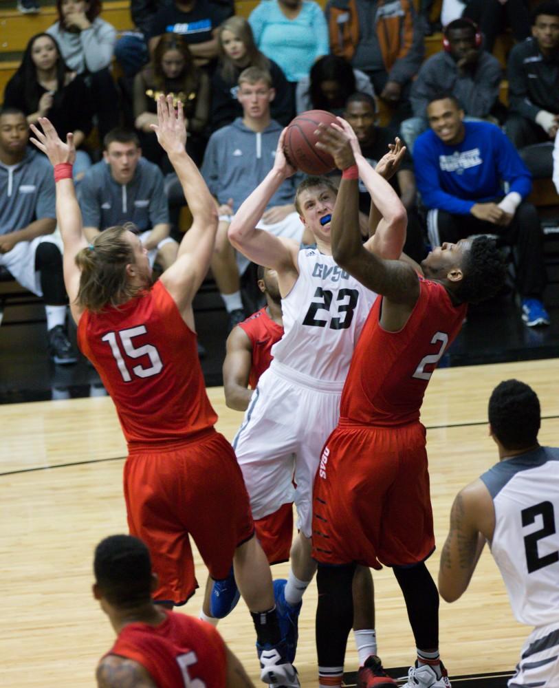 GVL / Kevin Sielaff - Luke Ryskamp (23) drives the ball into traffic. The Lakers defeat the Cardinals of SVSU with a final score of 76-73 in Allendale.