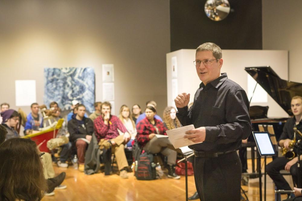 GVL / Sara Carte - Music Director, Bill Ryan, speaks about the music at the New Music Ensemble Student Competition in the Performing Arts Center on Thursday, Feb. 25, 2016.