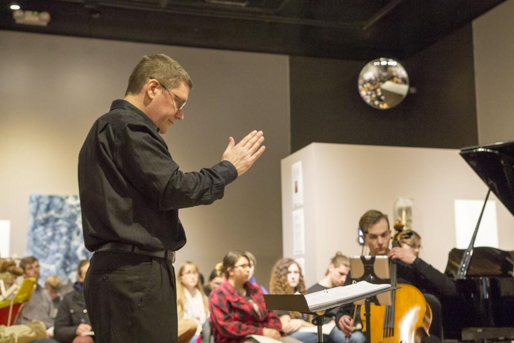 GVL / Sara Carte - Music Director, Bill Ryan, directs during the performance at the New Music Ensemble Student Competition in the Performing Arts Center on Thursday, Feb. 25, 2016.