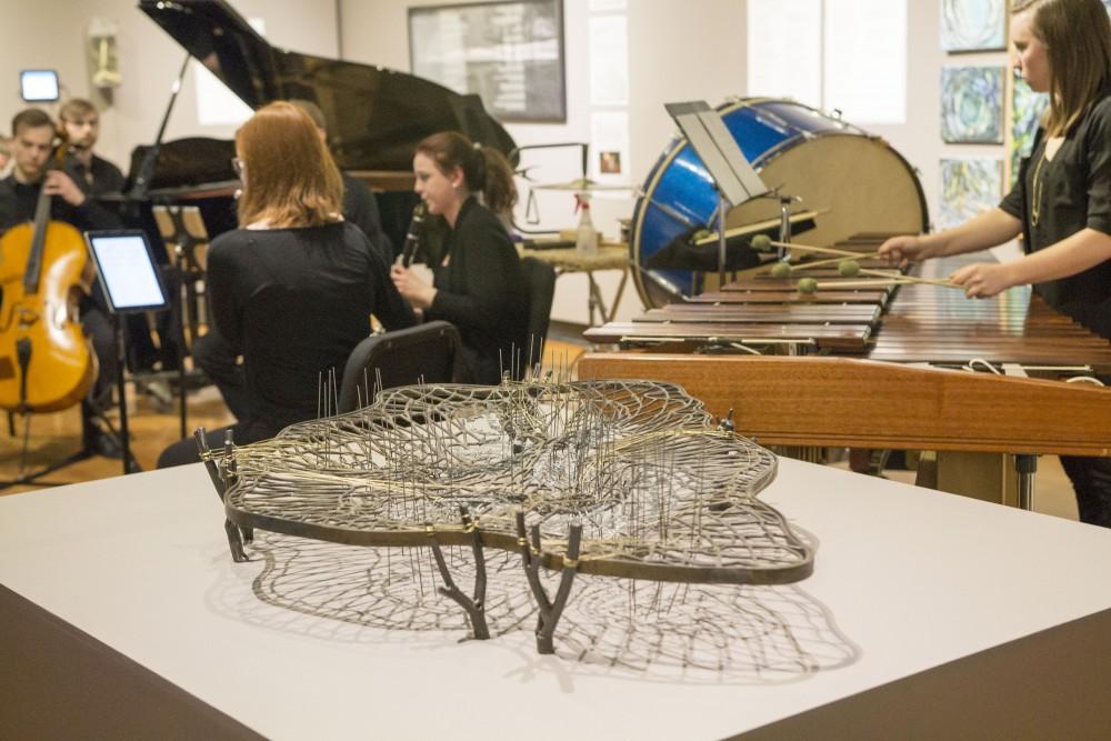 GVL / Sara Carte - Music Director, Bill Ryan, and music students perform musical pieces in response to the Art Gallery show “Great Lakes: Image & Word” at the New Music Ensemble Student Competition in the Performing Arts Center on Thursday, Feb. 25, 2016.