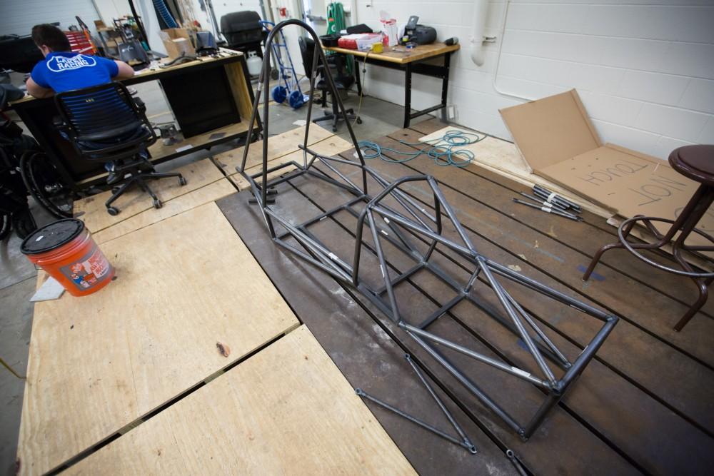 GVL / Kevin Sielaff - The nearly finished race car chassis sits behind the work bench where welding is taking place on Saturday, Feb. 27, 2016 inside the vehicle bay at Grand Valley’s John C. Kennedy Hall of Engineering.