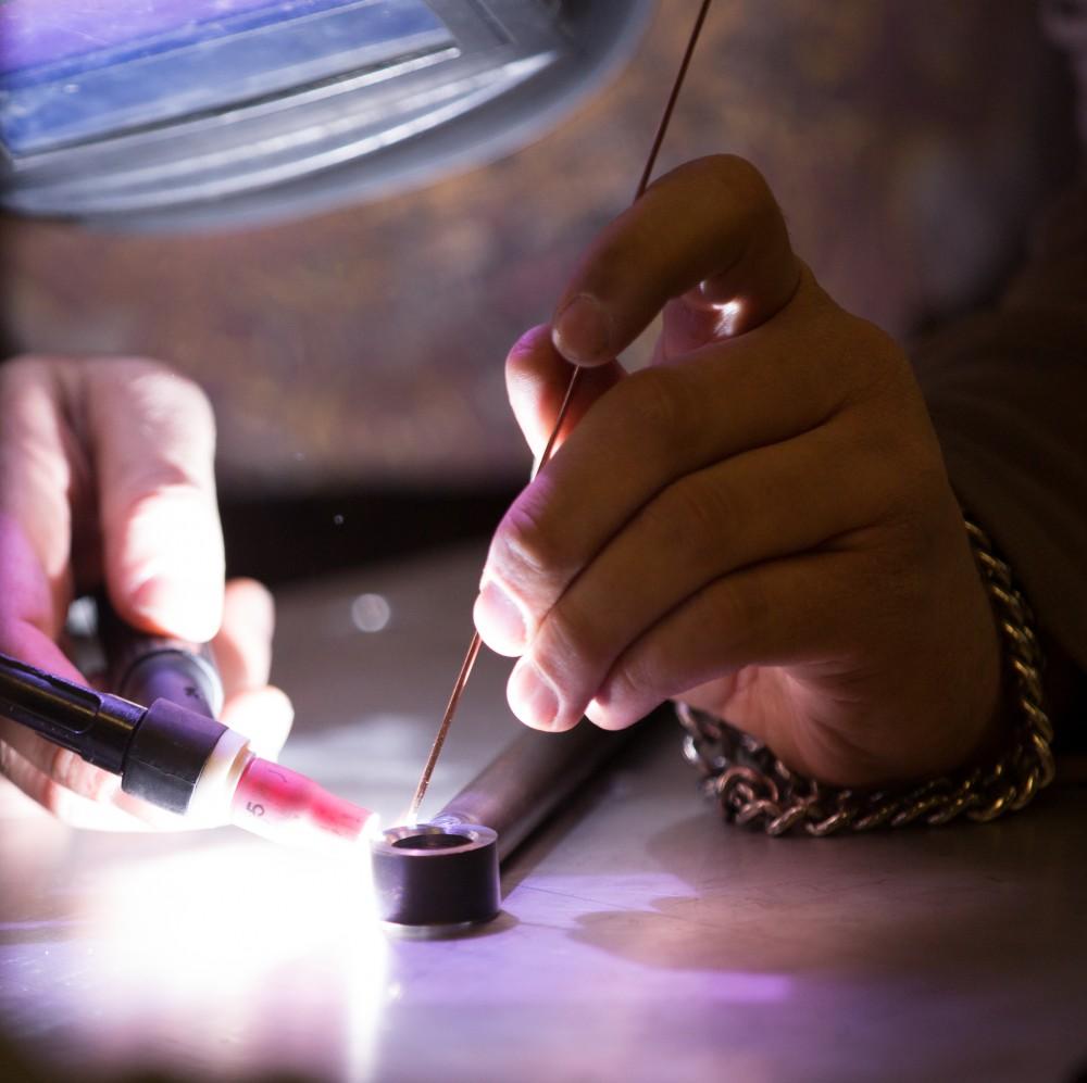 GVL / Kevin Sielaff -  Contracted welder Jake Dykstra performs the finishing touches on all of the vehicle’s a-arms Saturday, Feb. 27, 2016 inside the vehicle bay at Grand Valley’s John C. Kennedy Hall of Engineering.