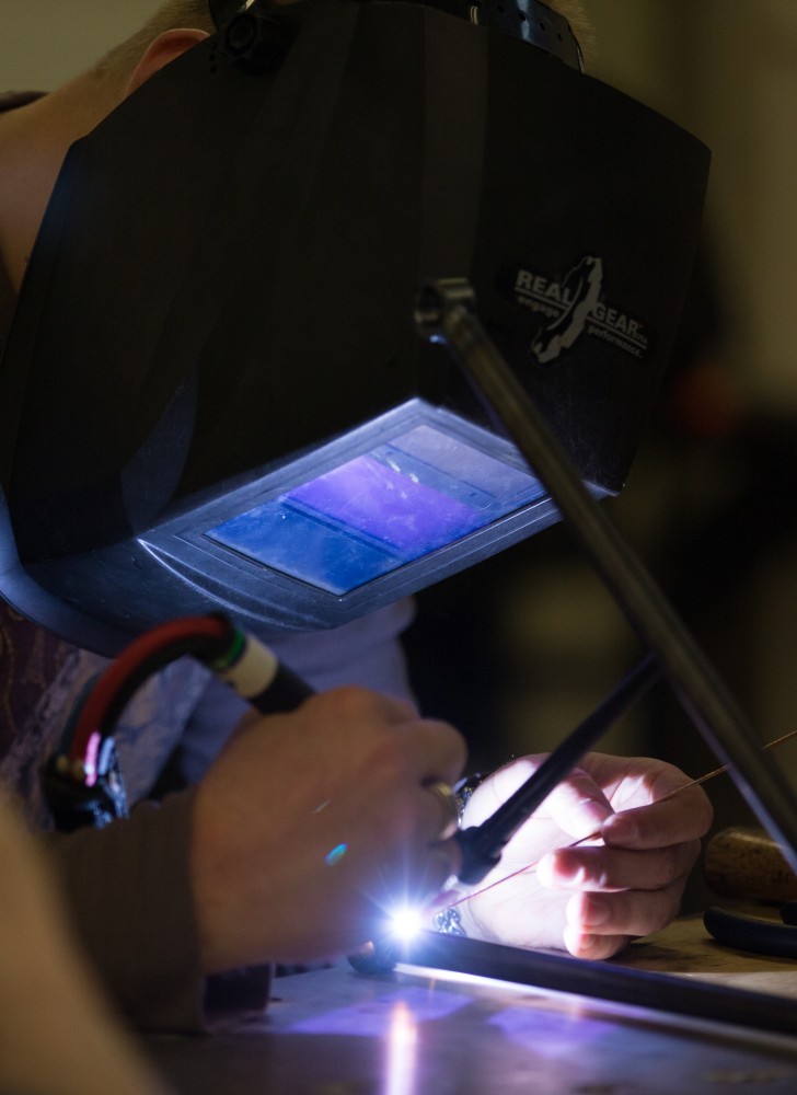 GVL / Kevin Sielaff -  Contracted welder Jake Dykstra performs the finishing touches on all of the vehicle’s a-arms Saturday, Feb. 27, 2016 inside the vehicle bay at Grand Valley’s John C. Kennedy Hall of Engineering.