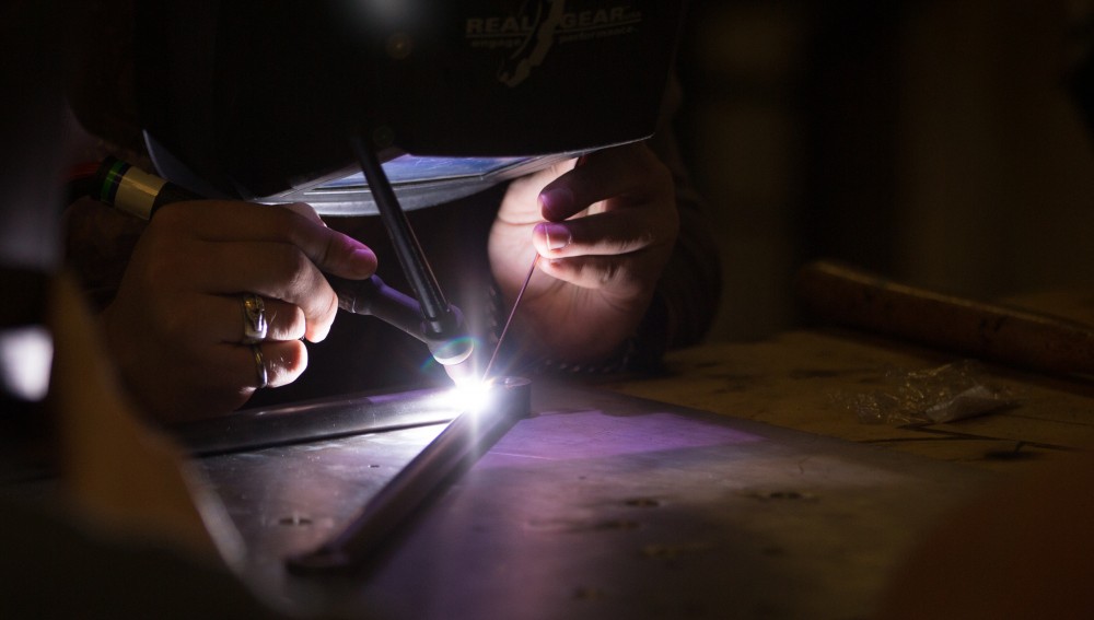 GVL / Kevin Sielaff -  Contracted welder Jake Dykstra performs the finishing touches on all of the vehicle’s a-arms Saturday, Feb. 27, 2016 inside the vehicle bay at Grand Valley’s John C. Kennedy Hall of Engineering.