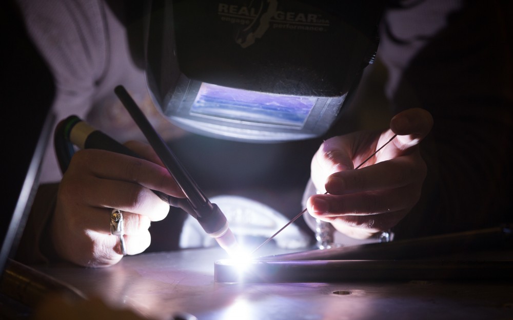 GVL / Kevin Sielaff -  Contracted welder Jake Dykstra performs the finishing touches on all of the vehicle’s a-arms Saturday, Feb. 27, 2016 inside the vehicle bay at Grand Valley’s John C. Kennedy Hall of Engineering.