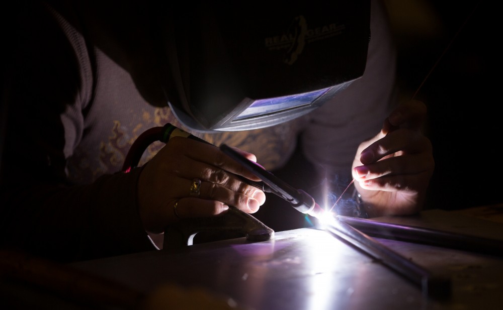 GVL / Kevin Sielaff -  Contracted welder Jake Dykstra performs the finishing touches on all of the vehicle’s a-arms Saturday, Feb. 27, 2016 inside the vehicle bay at Grand Valley’s John C. Kennedy Hall of Engineering.