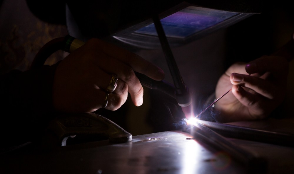 GVL / Kevin Sielaff -  Contracted welder Jake Dykstra performs the finishing touches on all of the vehicle’s a-arms Saturday, Feb. 27, 2016 inside the vehicle bay at Grand Valley’s John C. Kennedy Hall of Engineering.