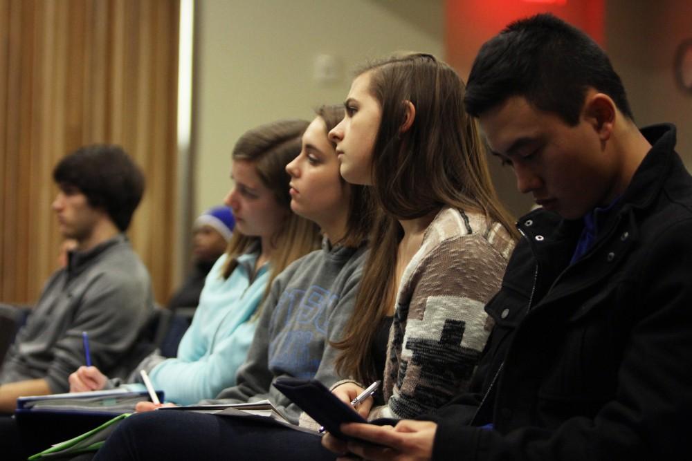 Many students, while attending the Scarlet Cord event, took notes during the speakers presentations on Feb. 4 in Allendale, MI. 