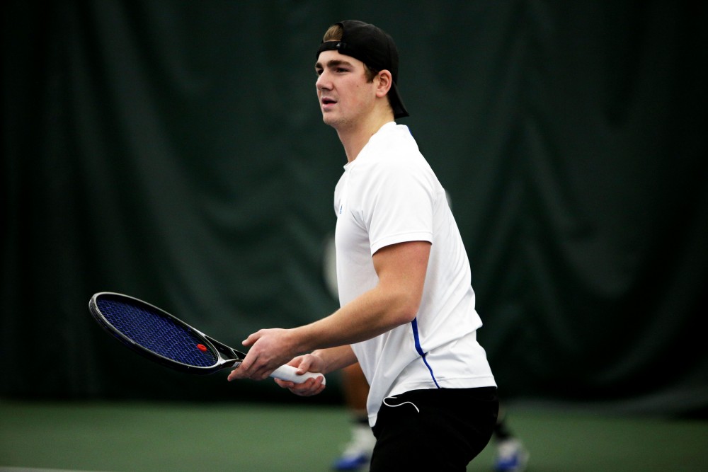 GVL / Emily Frye 
Junior Zach Phillips prepares to return the serve against Davenport on Friday Feb. 19, 2016.