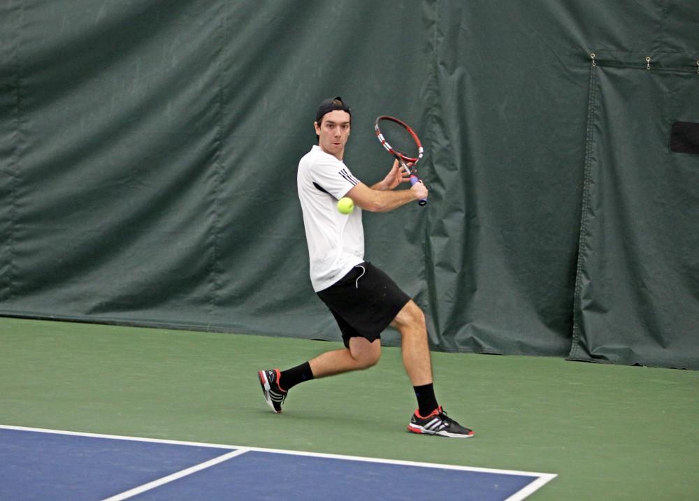 GVL / Emily Frye 
Senior Andrew Bole returns the serve against Davenport University on Friday Feb. 19, 2016.