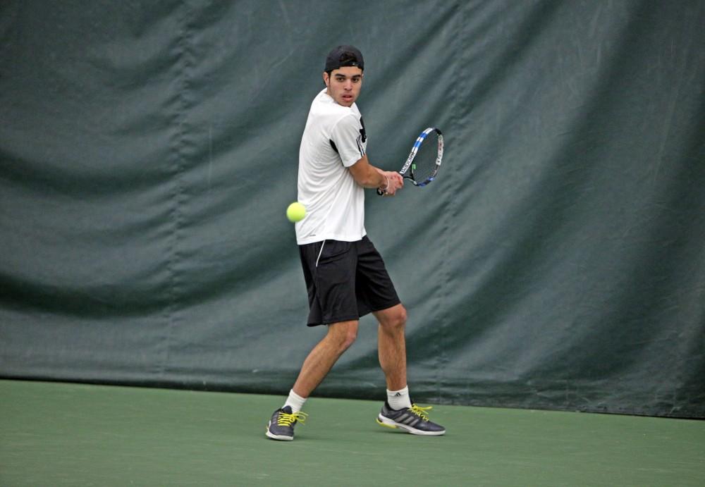 GVL / Emily Frye 
Junior Jack Heiniger returns a serve against Davenport University on Friday Feb. 19, 2016.