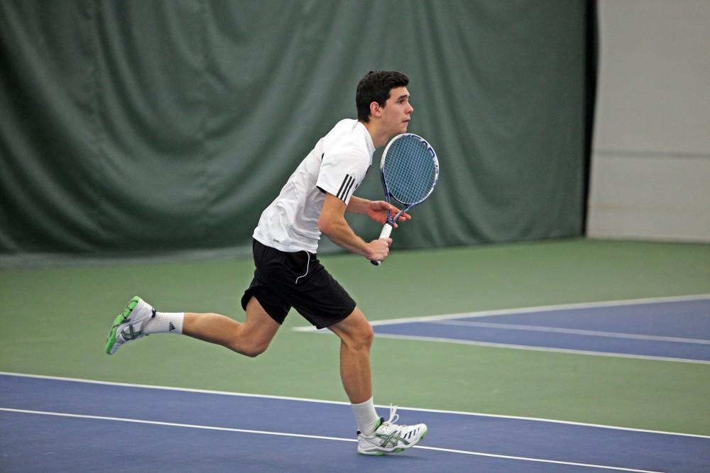 GVL / Emily Frye 
Junior Jack Heiniger returns a serve against Davenport University on Friday Feb. 19, 2016.